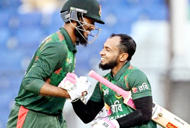 Bangladesh's Mushfiqur Rahim (R) and Rishad Hossain celebrate after their victory at the third and last one-day international (ODI) cricket match between Bangladesh and Sri Lanka in the Zahur Ahmed Chowdhury Stadium of Chittagong on March 18, 2024.