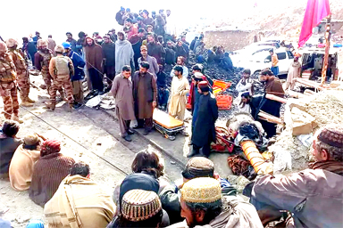 Miners gather outside a collapsed coalpit as rescue personnel search for trapped workers after a gas explosion in Balochistan province, Pakistan, on March 20, 2024