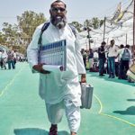 An election official leaves after collecting an Electronic Voting Machine (EVMs) from a polling materials distribution centre in Haridwar on April 18, 2024, on the eve of phase one of India's general election.