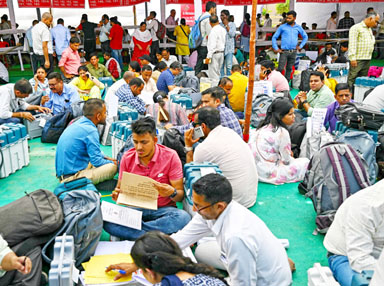 Election officials make preparations after collecting Electronic Voting Machines from a polling materials distribution centre in Haridwar on Thursday, on the eve of phase one of India’s general election.