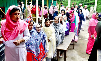 Women wait to cast their votes at a polling station during the first phase of the general election, in Imphal, Manipur, India, April 19, 2024.