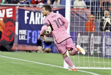 Inter Miami forward Lionel Messi (10) retrieves the ball from the net after scoring in the first half of an MLS soccer match against the New England Revolution, Saturday, April 27, 2024, in Foxborough, Mass.