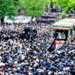 People participate in a funeral procession alongside a lorry carrying the coffins of president Ebrahim Raisi and his seven aides in Tabriz, East Azerbaijan province, on May 21, 2024.